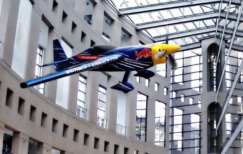 Red Bull Air Racer model flying indoor at a shopping mall event.